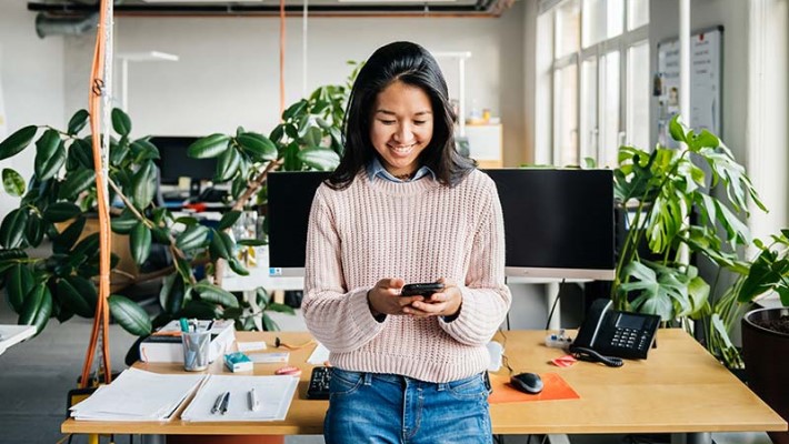 Happy employee in a green office, smiling.