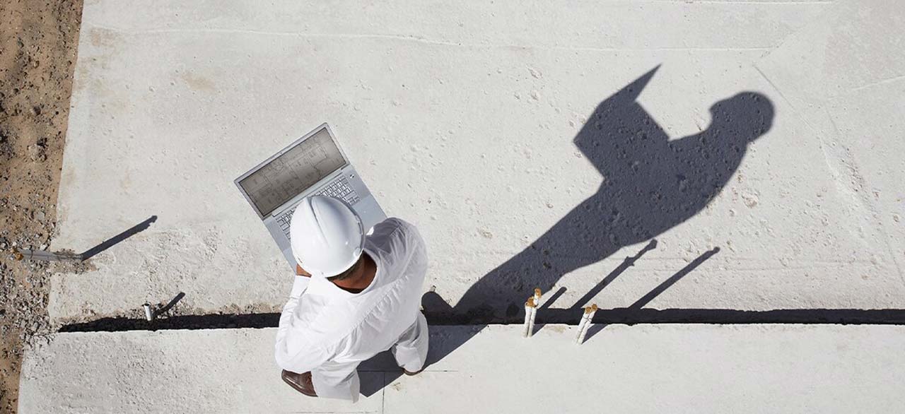 foreman with laptop at new construction site