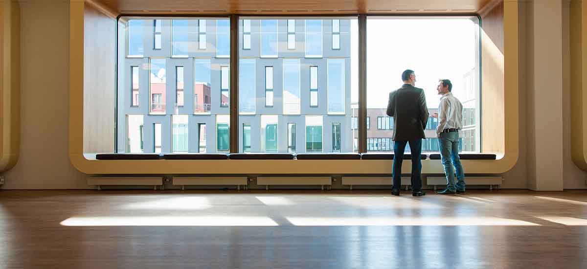 two people looking through window