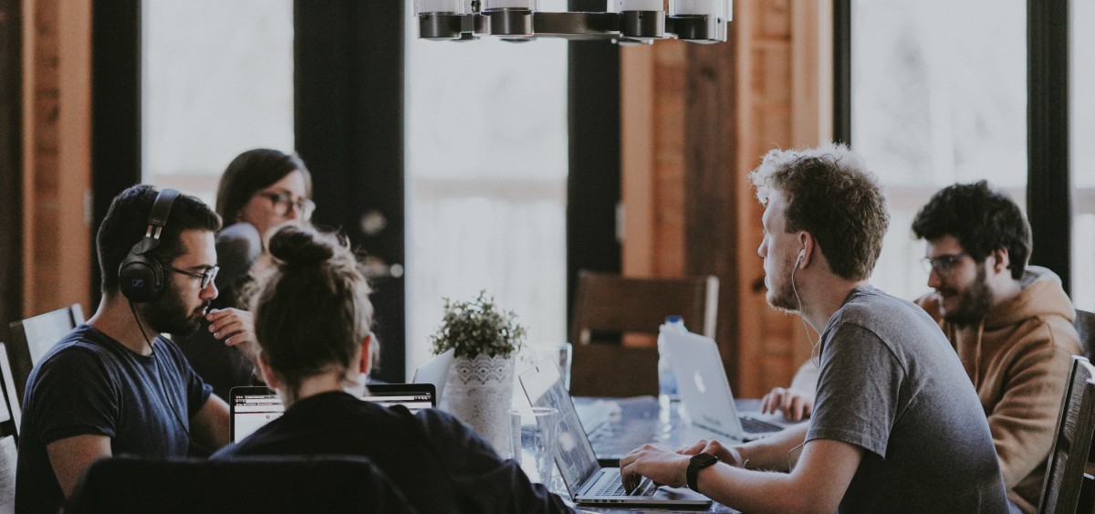 people sitting around a table in a coworking space