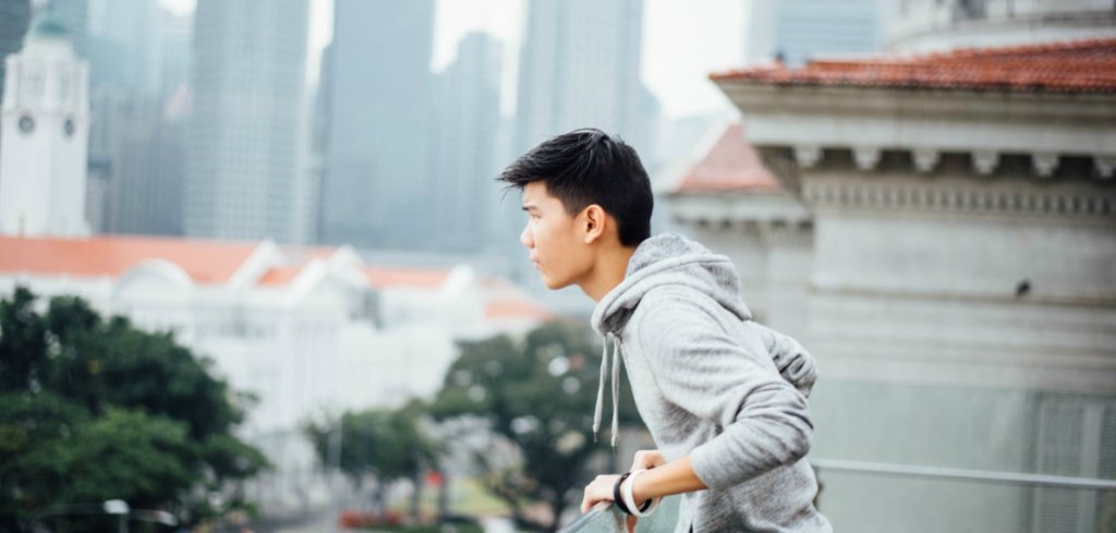 young male asian looking out