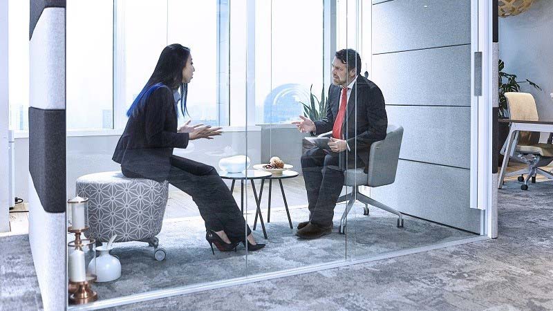 Colleagues having a business conversation in the office conference room