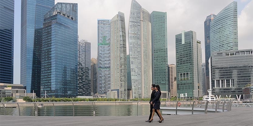 Business people walking past by skyscraper building