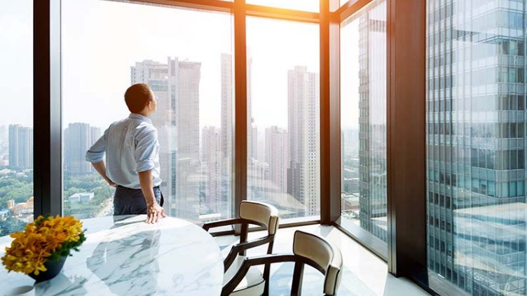 Man looking outside from office window 