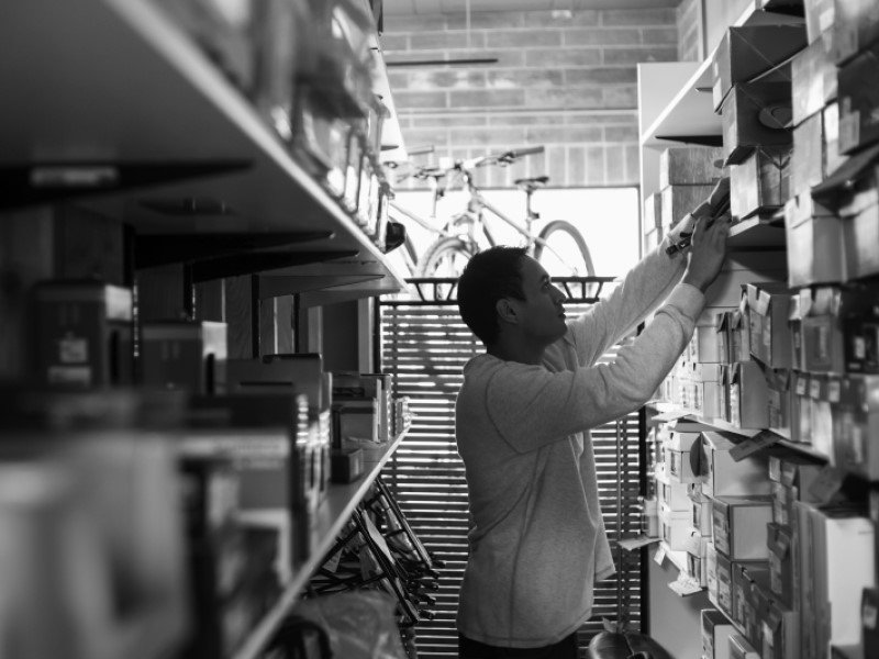 Store worker working and stocking shelves at supermarket store
