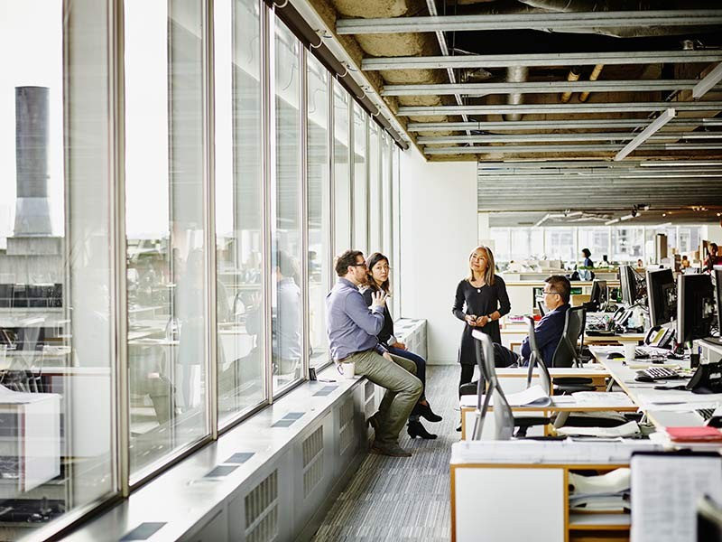 Employees discussing something in office
