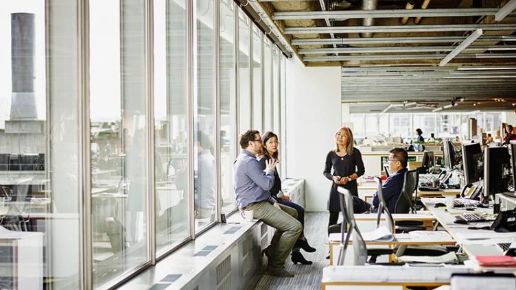 Employees discussing something in office