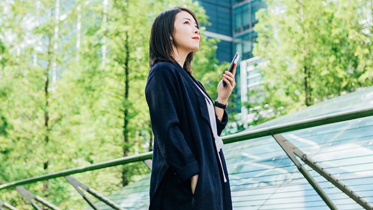 Women standing with a mobile