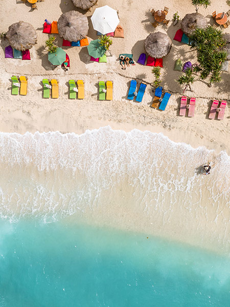Sandy beach with colorful sun umbrella