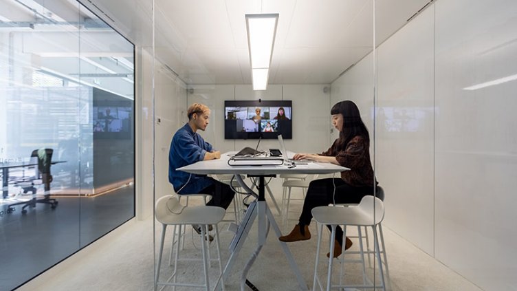 a man and a woman in a meeting room