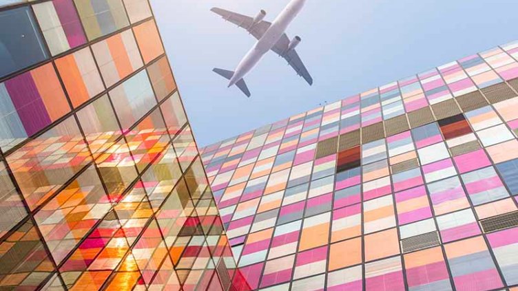 Airplane is flying above the building