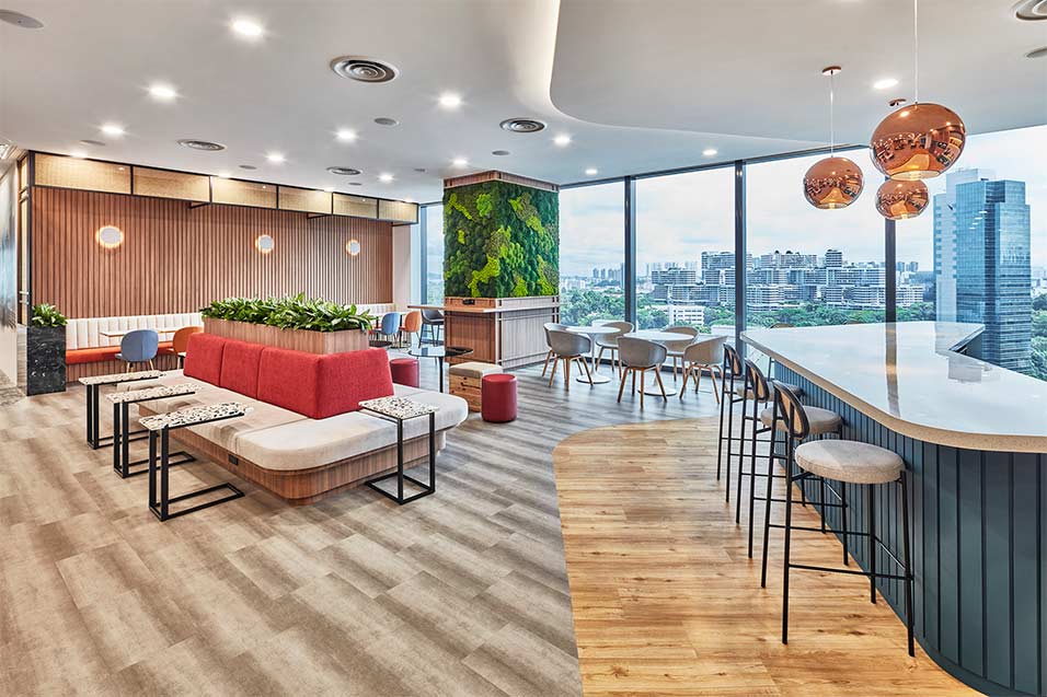 Modern social hub with various seating and office greenery at Hilti Singapore
