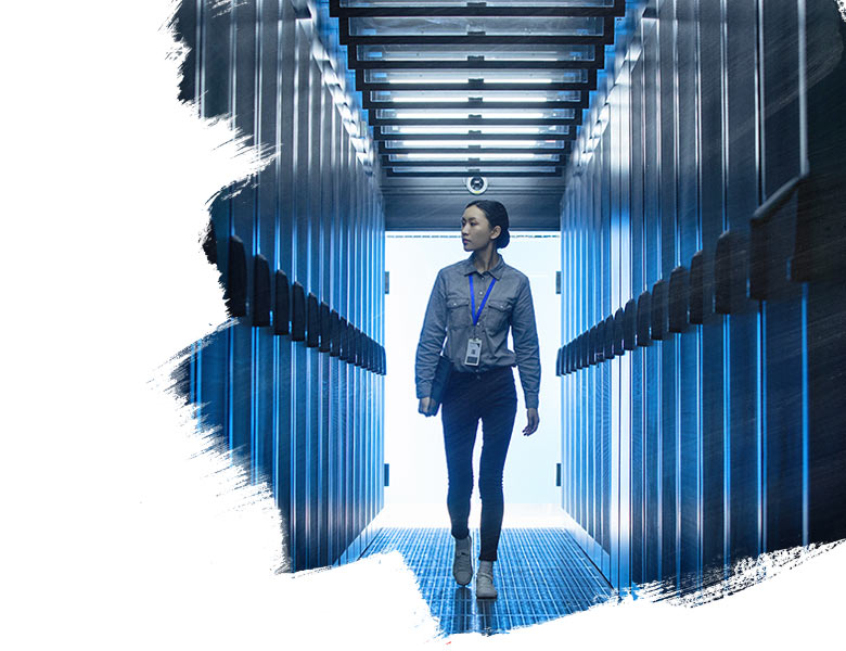 A lady with a lanyard walking through a data centre facility