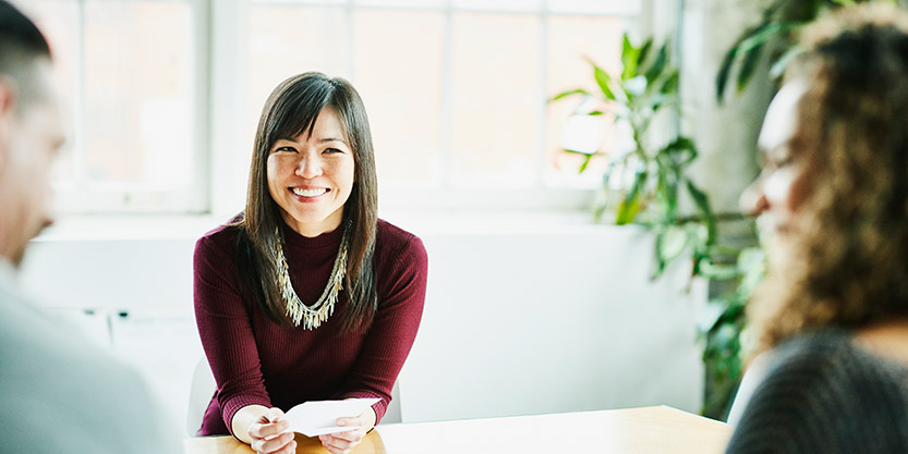 woman sitting across the table smiling