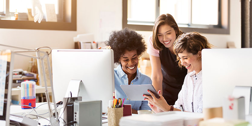 three women looking at tablet's screen