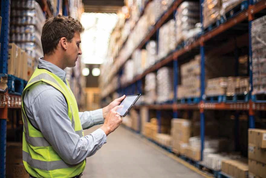 Warehouse worker checking the stock price in his tablet