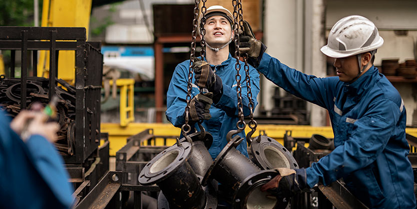 Blue collar workers working in steel factory