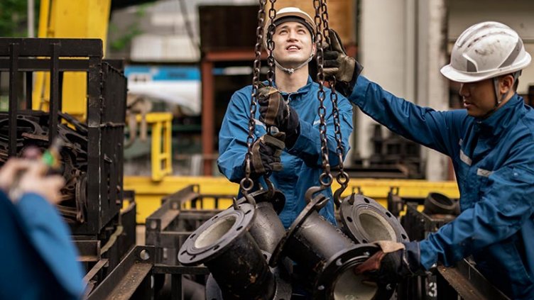 Blue collar workers working in steel factory