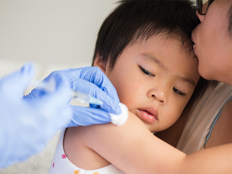 Child receives a vaccine shot