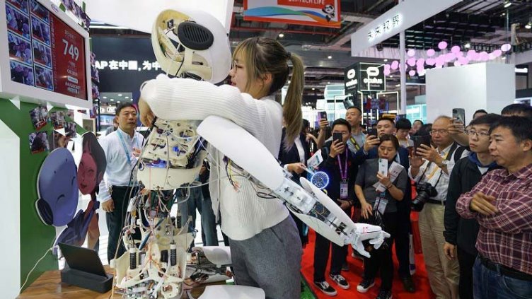 woman hugging the robot at International Import Expo