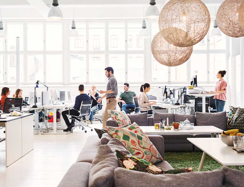 A busy, collaborative office with people moving around