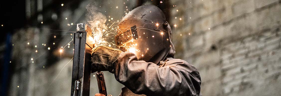 Worker welding the steel