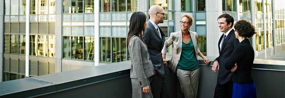 Diverse group of business people in discussion on a terrace in a central business district location