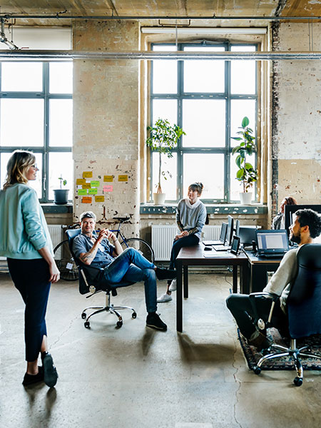 Group of colleagues communicating in a hybrid workspace