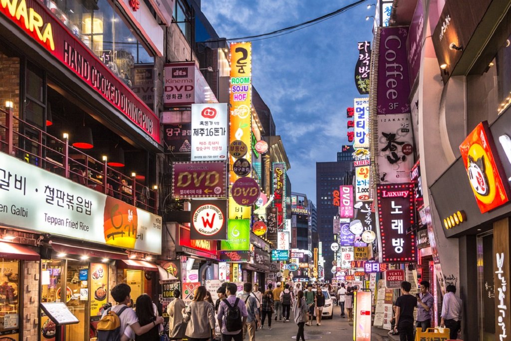 SEOUL, SOUTH KOREA - SEPTEMBER 12 2015: People wander in the walking street of the Myeong-dong shopping and entertainment district at night.; Shutterstock ID 332391542; Cost Center: JLL; Region: Global