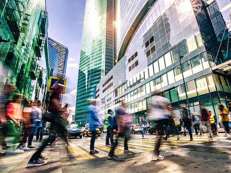 pedestrian crossing road in busy city