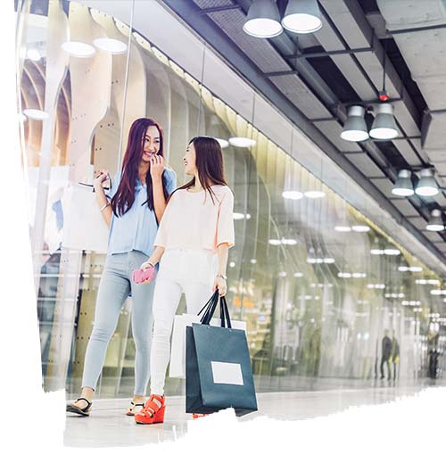 Two women talking and roaming inside the shopping mall