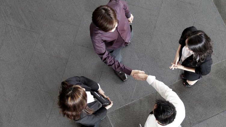 Top view of the employees meeting and shaking hands